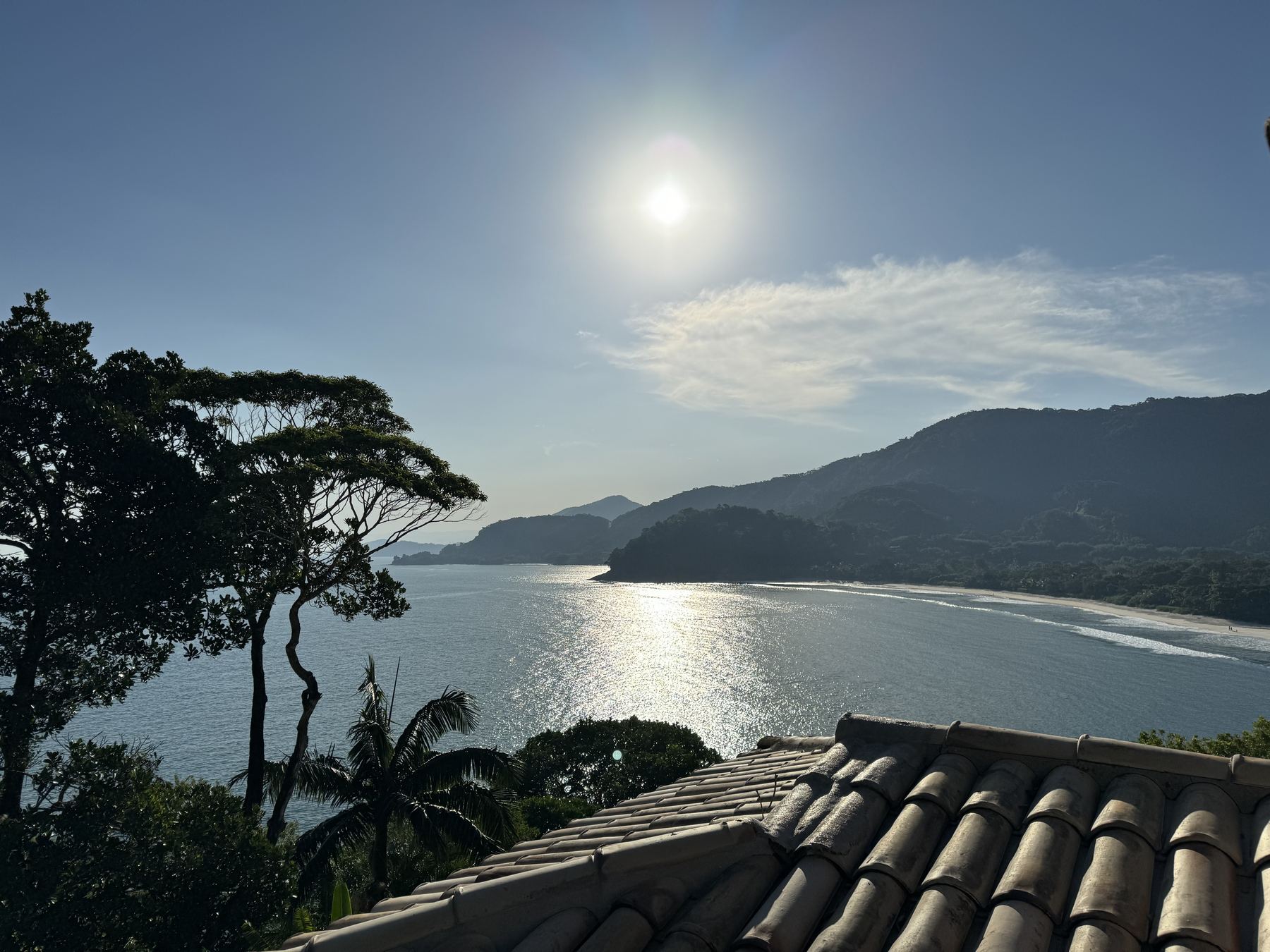 Sun over the bay seen from the chalé roofline